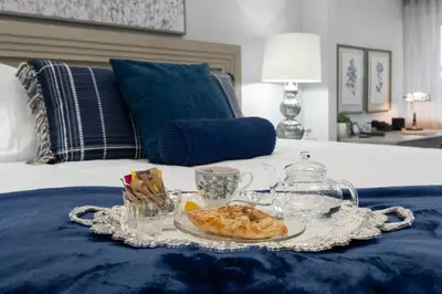 a tray with a plate of food on a bed at Gulf Highlands #177 by Nautical Properties in Panama City Beach