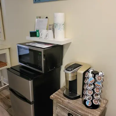 a kitchen with a coffee maker and a microwave at Ocean Front Studio with Epic Gulf Views in Panama City Beach