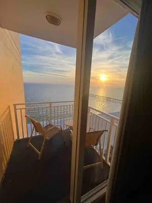 a balcony with a table and chairs and the ocean at Ocean Front Studio with Epic Gulf Views in Panama City Beach