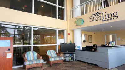 a store front with two chairs and a television at Ocean Front Studio with Epic Gulf Views in Panama City Beach