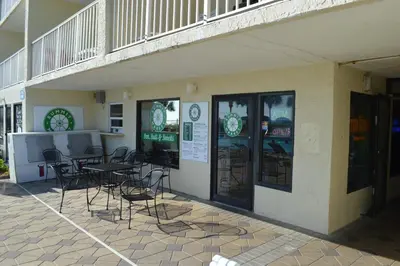a restaurant with tables and chairs outside of a building at The Summit Condominiums in Panama City Beach