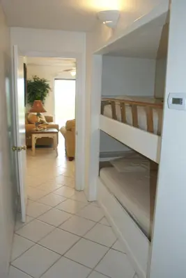 a hallway with a staircase leading to a living room at The Summit Condominiums in Panama City Beach