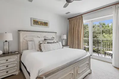 a white bedroom with a bed and a window at WaterHouse 202 in Inlet Beach