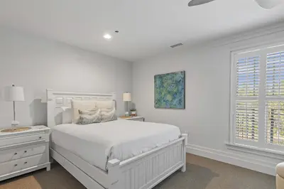 a white bedroom with a white bed and a window at WaterHouse 202 in Inlet Beach