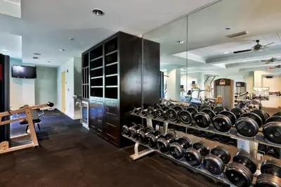 a gym with a bunch of dumbbells on display at WaterHouse 202 in Inlet Beach