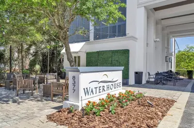 a sign for a water house in front of a building at WaterHouse 202 in Inlet Beach