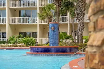 a pool with a fountain in front of a hotel at Shores Of Panama #0924 in Panama City Beach
