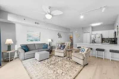 a living room with a couch and chairs and a kitchen at Shores Of Panama #0924 in Panama City Beach
