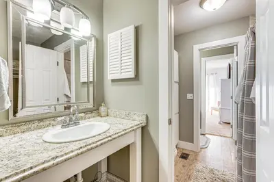 a bathroom with a sink and a mirror at Walk to Beach PCB Gem with Community Pool Access! in Panama City Beach