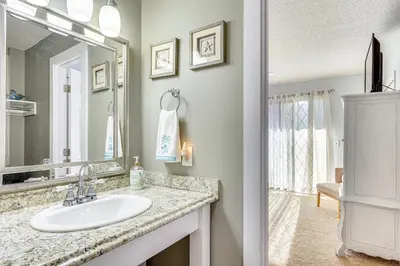 a bathroom with a sink and a mirror at Walk to Beach PCB Gem with Community Pool Access! in Panama City Beach