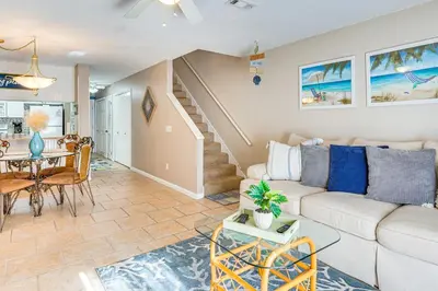 a living room with a couch and a table at Walk to Beach PCB Gem with Community Pool Access! in Panama City Beach