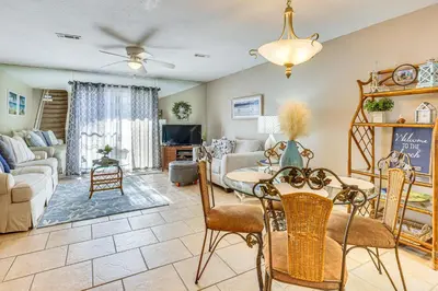 a living room with a table and chairs at Walk to Beach PCB Gem with Community Pool Access! in Panama City Beach