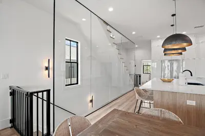 a kitchen with white walls and a table and chairs at LegaSea on 30A in Inlet Beach