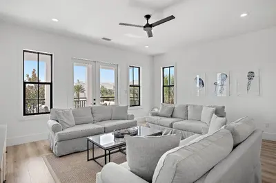 a living room with two couches and a ceiling fan at LegaSea on 30A in Inlet Beach