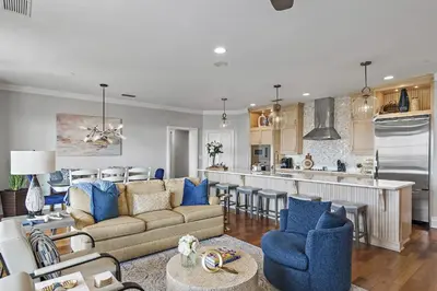 a living room with a couch and a kitchen at WaterHouse 304- Open Air in Inlet Beach