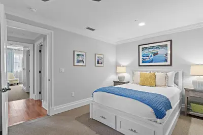 a white bedroom with a bed and two lamps at WaterHouse 304- Open Air in Inlet Beach