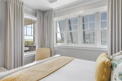 a bedroom with a bed and two windows at WaterHouse 304- Open Air in Inlet Beach