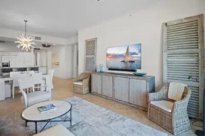 a living room with a tv and a table and chairs at Beach Haven in Inlet Beach
