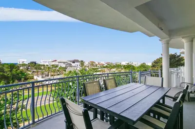 a table and chairs on a balcony with a view of the ocean at Beach Haven in Inlet Beach