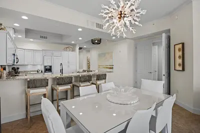 a kitchen with a white table and white chairs at Beach Haven in Inlet Beach