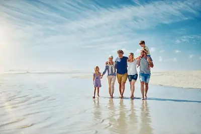 a group of people standing on the beach at Beach Haven in Inlet Beach