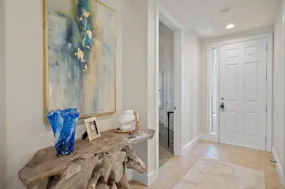 a room with a table with a vase on it at Beach Haven in Inlet Beach