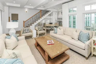 a living room with a couch and a table at Harp's Haven Main House in Inlet Beach