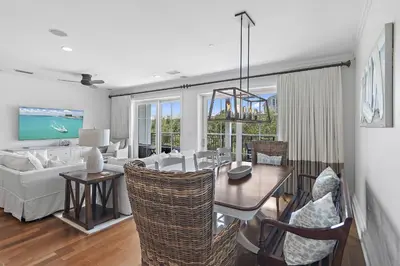 a living room with a dining table and a couch at WaterHouse 204 in Inlet Beach