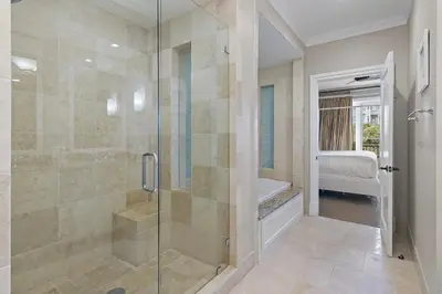 a bathroom with a shower with a glass door at WaterHouse 204 in Inlet Beach