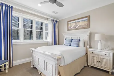 a bedroom with a white bed and windows at WaterHouse 204 in Inlet Beach