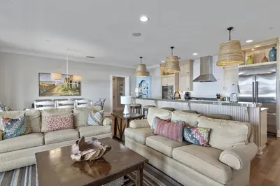 a living room with two couches and a kitchen at WaterHouse 402 in Inlet Beach