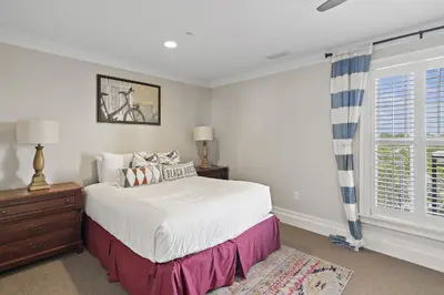 a bedroom with a bed and a window at WaterHouse 402 in Inlet Beach