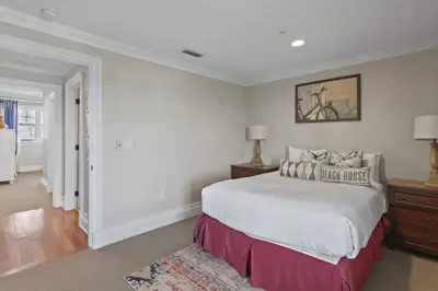 a white bedroom with a large bed and a rug at WaterHouse 402 in Inlet Beach