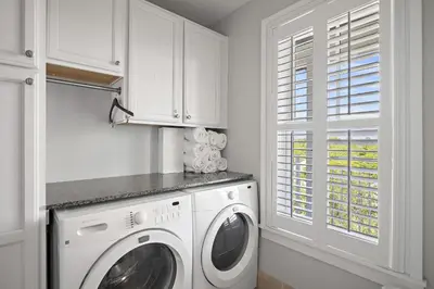 a white laundry room with a washer and dryer at WaterHouse 402 in Inlet Beach