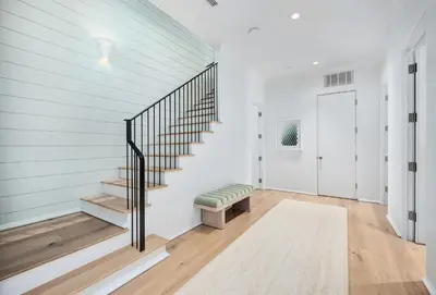 a staircase in a home with white walls at 74 Elysee Court in Inlet Beach