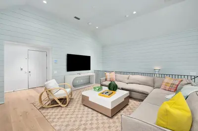 a living room with a couch and a tv at 74 Elysee Court in Inlet Beach