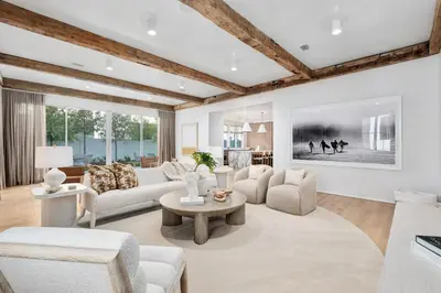 a living room with white furniture and a large window at 74 Elysee Court in Inlet Beach