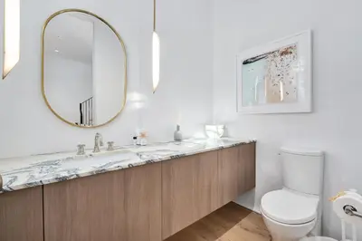 a bathroom with a sink and a toilet and a mirror at 74 Elysee Court in Inlet Beach