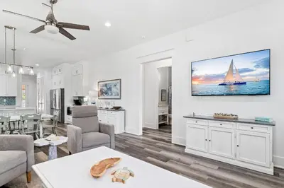a living room with a tv on a wall at Vitamin Sea of Seagrove in Santa Rosa Beach