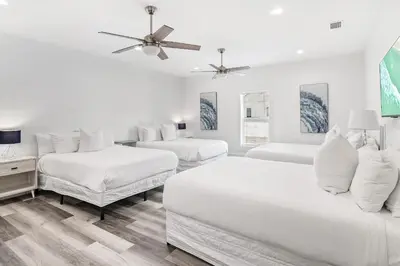 a white room with three beds and a couch at Vitamin Sea of Seagrove in Santa Rosa Beach