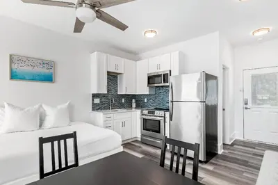 a white kitchen with a bed and a refrigerator at Vitamin Sea of Seagrove in Santa Rosa Beach