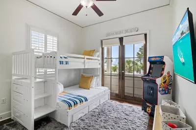 a bedroom with a bunk bed and a video game at Southern Coastal in Inlet Beach