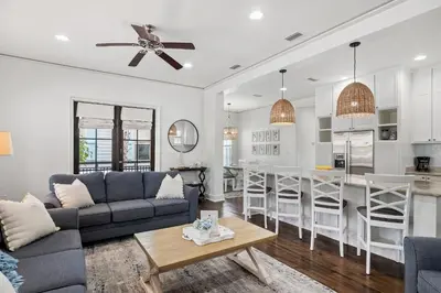 a living room and kitchen with a couch and a table at Southern Coastal in Inlet Beach