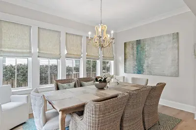 a dining room with a table and chairs and a chandelier at 28 Dalton Drive in Santa Rosa Beach