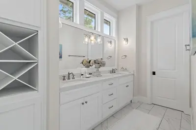 a white bathroom with a sink and a mirror at 28 Dalton Drive in Santa Rosa Beach
