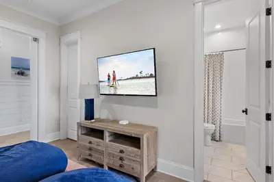 a living room with a tv on a wall at 28 Dalton Drive in Santa Rosa Beach
