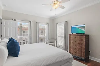 a bedroom with a bed and a flat screen tv at Fintastic in Santa Rosa Beach