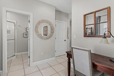 a dining room with a table and a mirror at Emerald Escape in Santa Rosa Beach