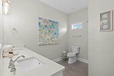 a white bathroom with a sink and a toilet at Emerald Escape in Santa Rosa Beach