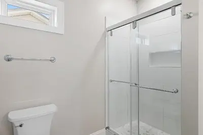 a glass shower in a bathroom with a toilet at Emerald Escape in Santa Rosa Beach